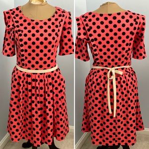 Flared party dress with structured shoulders and pockets